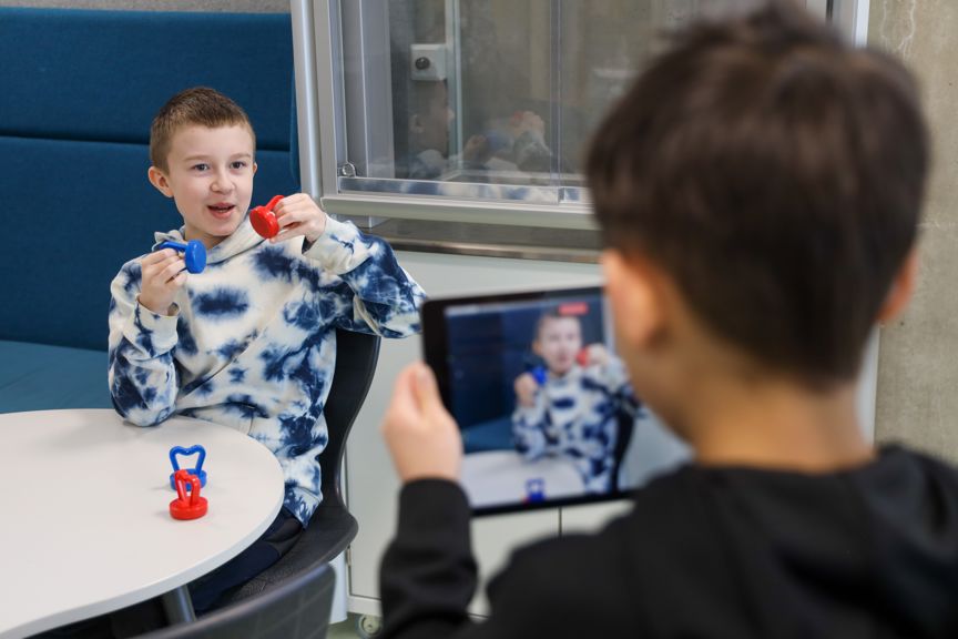 En elev filmer en annen elev forklare om magnetisme